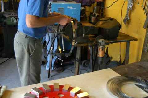 We now use stainless steel banding around the magnet rotors; it's 0.30 inches thick (about 1/32 inch) and 3/4 inch wide
