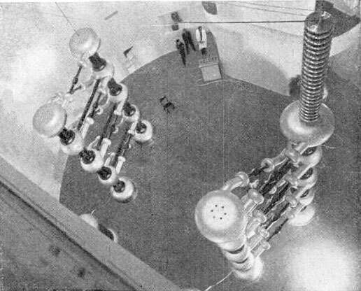 This Cockcroft-Walton full wave multiplier is shown at the Kaiser Wilhelm Institute in 1937. 3 MV could be generated by two 4-stage multipliers. Note the three people standing in the background.