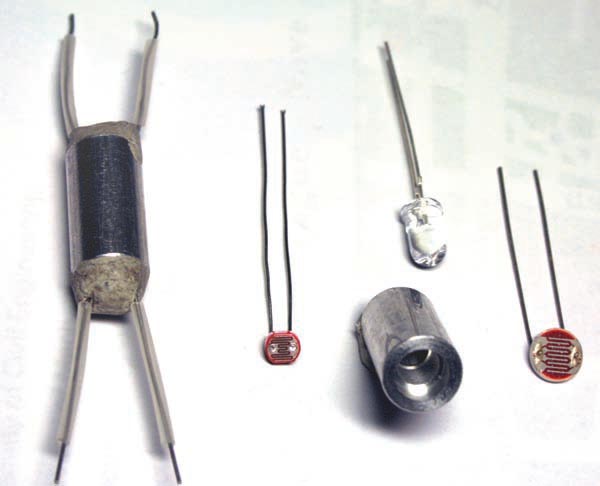 Оптоизолятор (слева) собран из яркого светодиода и фоторезистора, заключенных в металлическую трубку.