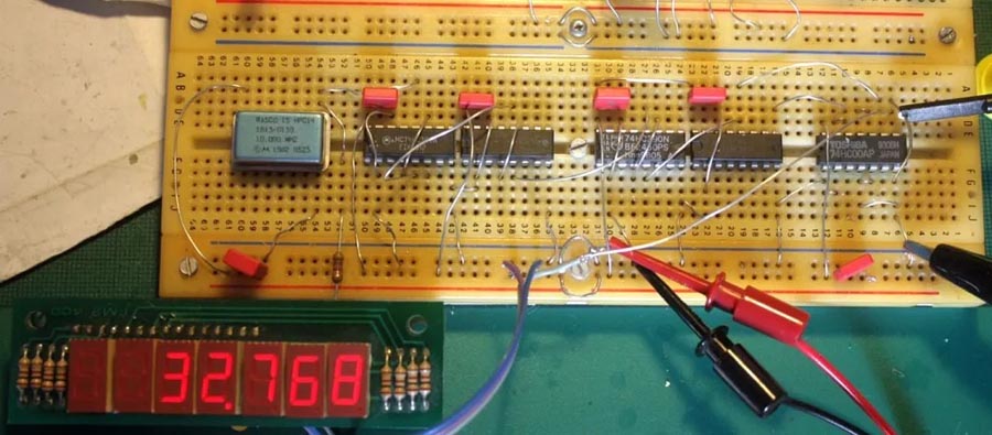 Breadboard implementation of divider chain with frequency counter.