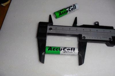 Measuring the length of the battery.